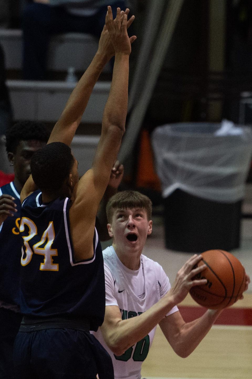 North’s Bryson Chapman (30) attempts to shoot the ball as he’s defended by Springfield Southeast’s Seth Doss (34) during the Bosse Winter Classic at Bosse High School in Evansville, Ind., Saturday afternoon, Dec. 17, 2022. 