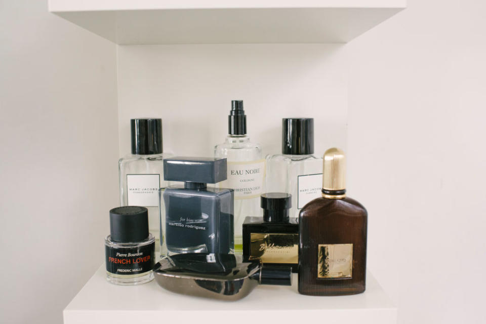 Various perfume bottles on a white shelf
