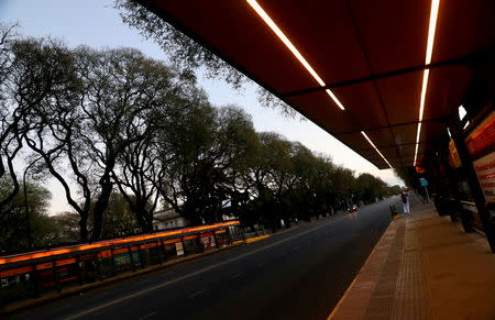 A woman stands next to an empty bus stop during a national strike in Buenos Aires, Argentina September 25, 2018. REUTERS/Marcos Brindicci