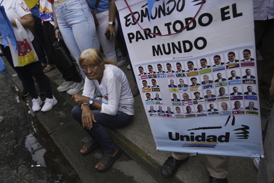 A supporter of opposition presidential candidate Edmundo Gonzalez holds a poster featuring the presidential ballot as thousands wait for his arrival at a campaign rally in Barinas, Venezuela, Saturday, July 6, 2024. The official campaign period for the July 28 election kicked off on July 4. (AP Photo/Ariana Cubillos)