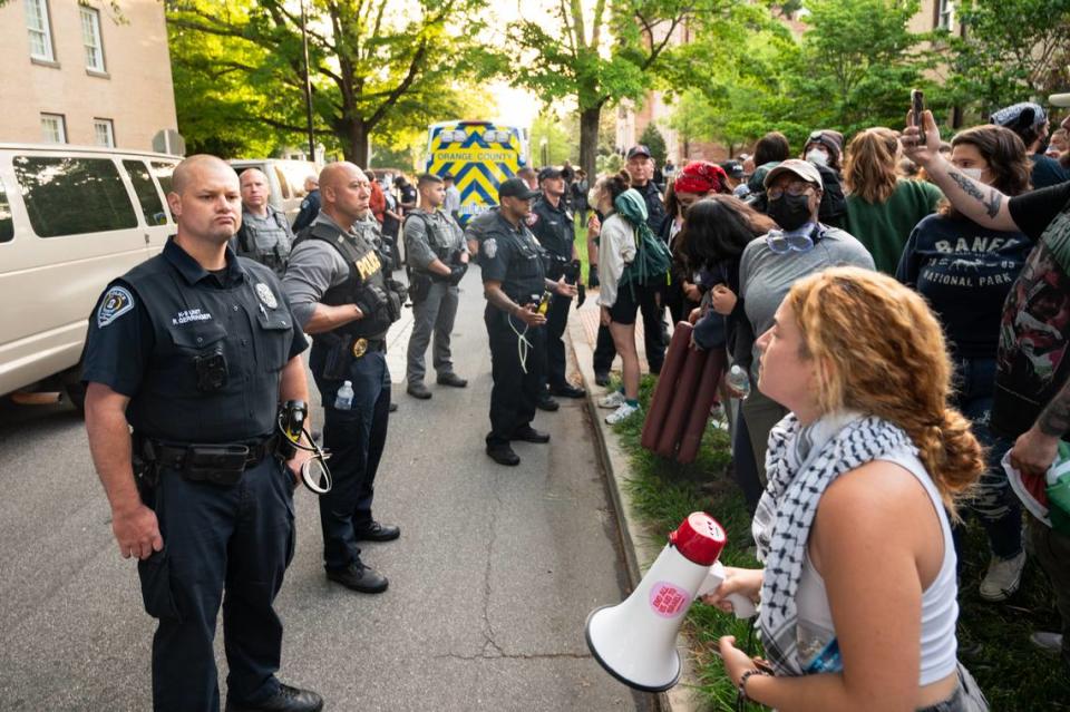 A line of police stand in front of protestors on E. Cameron Ave. on Tuesday, April 30.