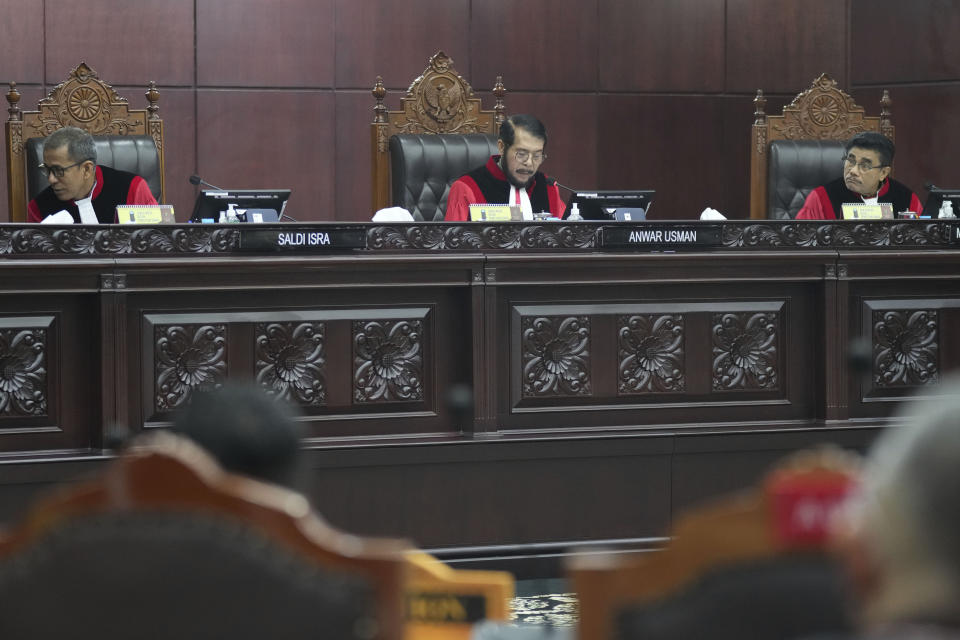 FILE - Chief Justice of the Constitutional Court Anwar Usman, top center, presides over the hearing on a petition seeking to lower the minimum age of presidential and vice presidential candidates at the Constitutional Court in Jakarta, Indonesia, Monday, Oct. 23, 2023. Ethics council chief Jimly Asshiddiqie said in a verdict that the Constitutional Court’s Chief Justice Anwar Usman found guilty of making last-minute changes to election candidacy requirements that cleared way for ongoing President Joko Widodo’s eldest son, Gibran Rakabuming Raka, 36, to run for vice president in the election next year. (AP Photo/Tatan Syuflana, File)