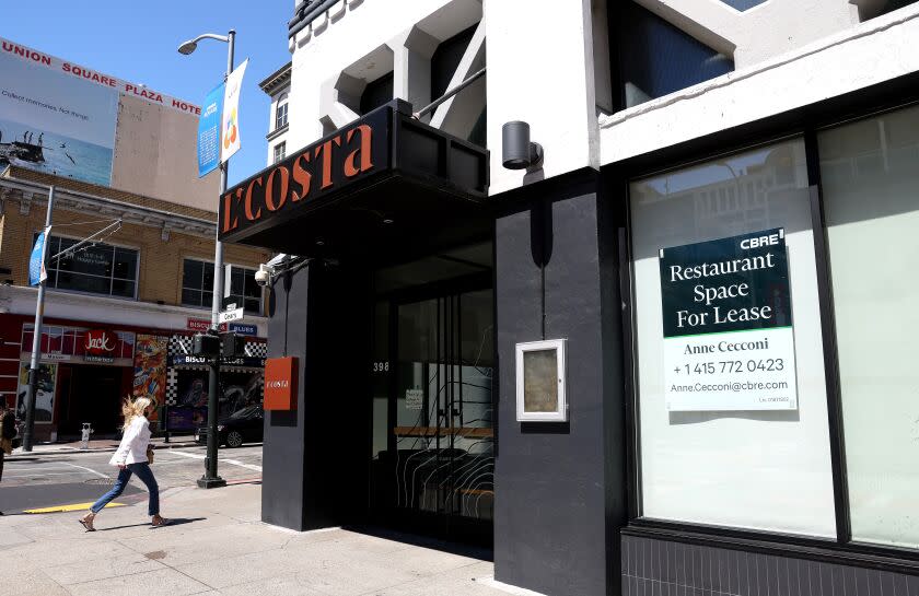 A pedestrian walks by a closed restaurant on August 25, 2022 in San Francisco, Calif.