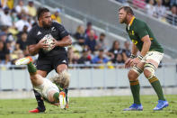 New Zealand's Nepo Laulala is tackled by South Africa's Faf de Klerk as South Africa's Duane Vermeulen, right, watches during the Rugby Championship test match between the Springboks and the All Blacks in Townsville, Australia, Saturday, Sept. 25, 2021. (AP Photo/Tertius Pickard)