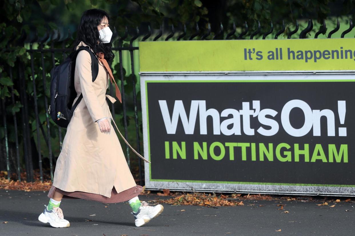 A woman wearing a face in Nottingham: PA