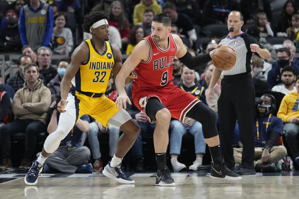 Chicago Bulls center Nikola Vucevic (9) moves to the basket in front of Indiana Pacers guard Terry Taylor (32) during the first half of an NBA basketball game in Indianapolis, Friday, Feb. 4, 2022. (AP Photo/AJ Mast)