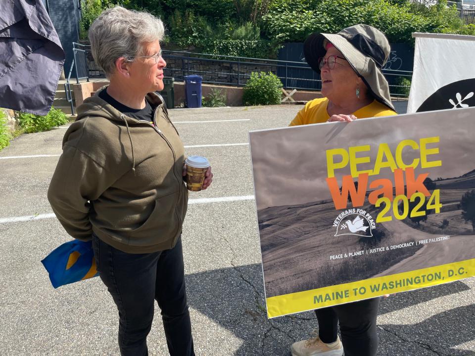 Wendy Novicki-Romano was passing by the Veterans for Peace demonstration, and stopped to talk with some of them, including associate member Alexis Ryon-Melcher.