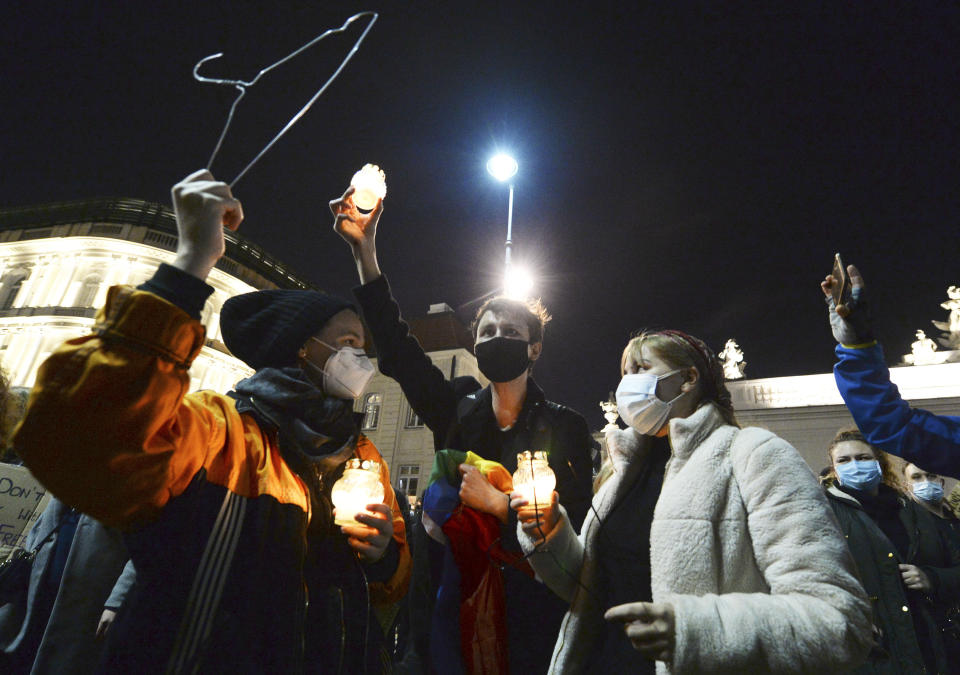 People protest against imposing further restrictions on abortion law in front of the Presidential palace in Warsaw, Poland, Sunday, Oct. 25, 2020. (AP Photo/Czarek Sokolowski)