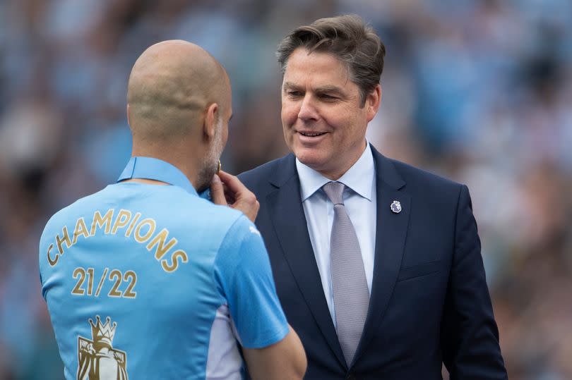 Premier League CEO Richard Masters congratulates Pep Guardiola on Manchester City winning the title in 2022