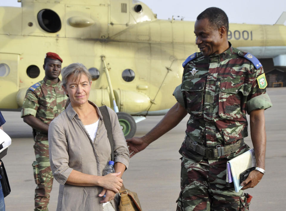 FILE - In this April 24, 2012, file photo, released Swiss hostage Beatrice Stoeckli, left, stands in Ouagadougou, Burkina Faso, following arrival by helicopter from Timbuktu, Mali, after being handed over by militant Islamic group Ansar Dine. Switzerland’s Foreign Ministry said Friday, Oct. 8, 2020, that Stoeckli has been killed by an Islamist group. The ministry said it was informed by French authorities that the hostage had been “killed by kidnappers of the Islamist terrorist organization Jama’at Nusrat al-Islam Muslimeen about a month ago.” Stoeckli was kidnapped four years ago. (AP Photo/Brahima Ouedraogo, File)