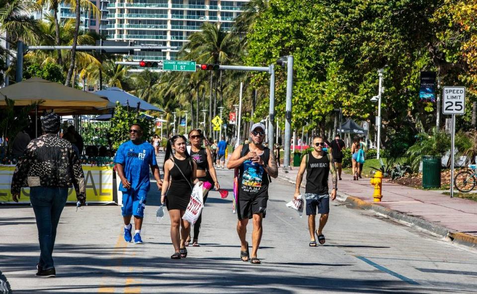 People enjoy the beautiful weather on Ocean Drive on March 2, 2021. The City of Miami Beach has implemented a ‘Vacation Responsibly’ campaign advising spring breakers of zero tolerance rules for public drunkenness, street fights, theft of any kind and illegal drug use.