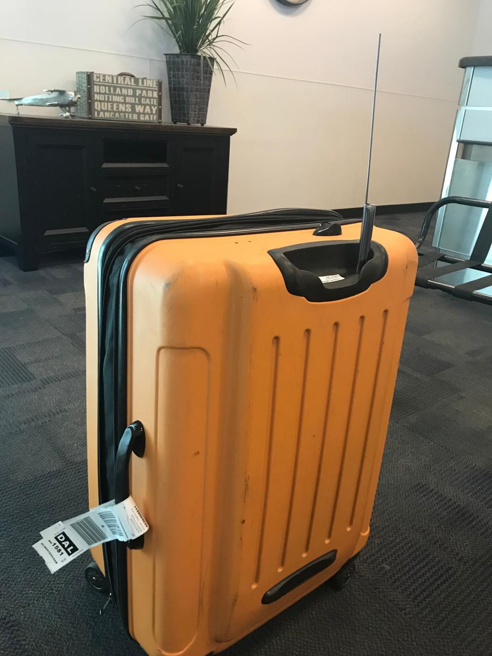 The handle on USA TODAY travel reporter Dawn Gilbertson's suitcase was destroyed on a flight from Phoenix to Dallas.