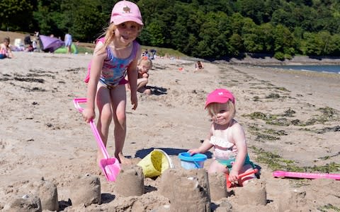 Youngsters cool off on a beach in Scotland - Credit: Corbis news