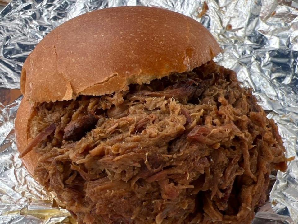 A sandwich stuffed with pulled pork.