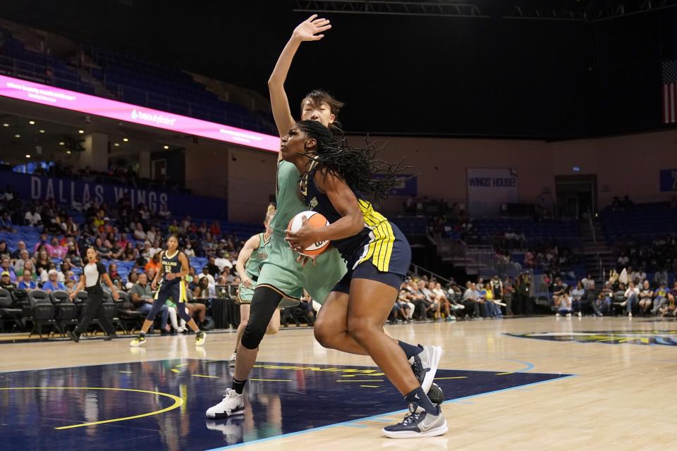 Dallas Wings center Teaira McCowan drives to the basket as New York Liberty center Han Xu defends during the first half of a WNBA basketball game in Arlington, Texas, Wednesday, Aug. 10, 2022. (AP Photo/Tony Gutierrez)