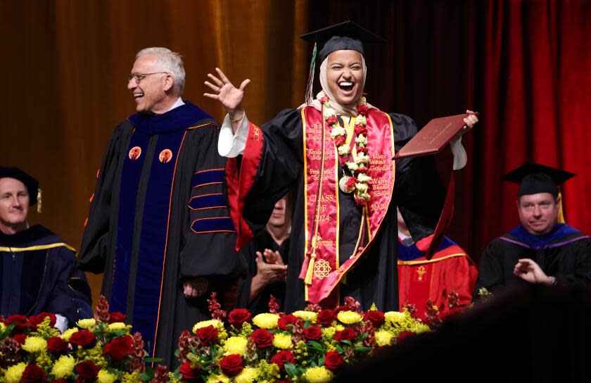 LOS ANGELES-CA-MAY 10, 2024: USC valedictorian Asna Tabassum receives her diploma on stage beside Dean of the USC Viterbi School of Engineering Yannis C. Yortsos at the Galen Center in Los Angeles on May 10, 2024. (Christina House / Los Angeles Times)