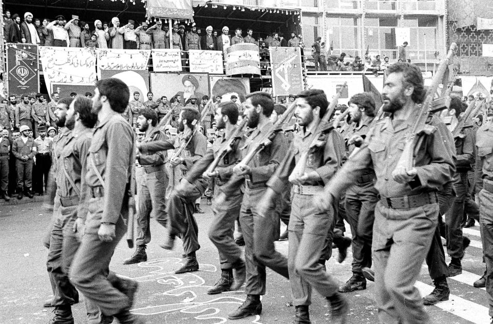 FILE - In this May 16, 1983 file photo, the newly established Islamic Revolutionary Guards Corps parade past the viewing stand in Tehran, Iran. On Monday, April 8, 2019, the Trump administration designated Iran’s Revolutionary Guard a “foreign terrorist organization” in an unprecedented move against a national armed force. Iran’s Revolutionary Guard Corps went from being a domestic security force with origins in the 1979 Islamic Revolution to a transnational fighting force. (AP Photo, File)