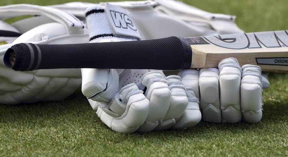 FILE - A close up view of cricket gloves and bat during the second day of the 2nd Test match between England and New Zealand at Edgbaston cricket ground in Birmingham, England, Friday, June 11, 2021. An independent commission has found that institutional racism, sexism and class-based discrimination continue to infect English cricket. A long-awaited report into the state of the sport was published by the Independent Commission for Equity in Cricket (ICEC). It found that reform was needed to “tackle discrimination, remove barriers and reform the game to make cricket more inclusive.” (AP Photo/Rui Vieira, File)