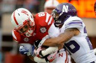 LINCOLN, NE - NOVEMBER 5: Wide receiver Kenny Bell #80 of the Nebraska Cornhuskers is wrapped up by cornerback Jordan Mabin #26 of the Northwestern Wildcats during their game at Memorial Stadium November 5, 2011 in Lincoln, Nebraska. Northwestern beat Nebraska 28-25. (Photo by Eric Francis/Getty Images)