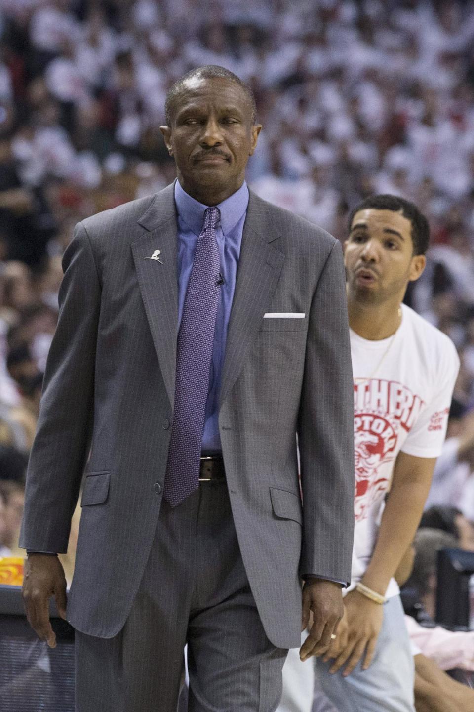 Toronto Raptors coach Dwane Casey, left, and rapper Drake react during Game 1 of an opening-round NBA basketball playoff series between the Raptors and the Brooklyn Nets, in Toronto on Saturday, April 19, 2014. The Nets won 94-87. (AP Photo/The Canadian Press, Chris Young)