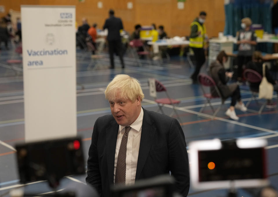 British Prime Minister Boris Johnson speaks to the media as he visits a COVID-19 vaccination centre at Little Venice Sports Centre, in London, Friday, Oct. 22, 2021. (AP Photo/Matt Dunham, Pool)