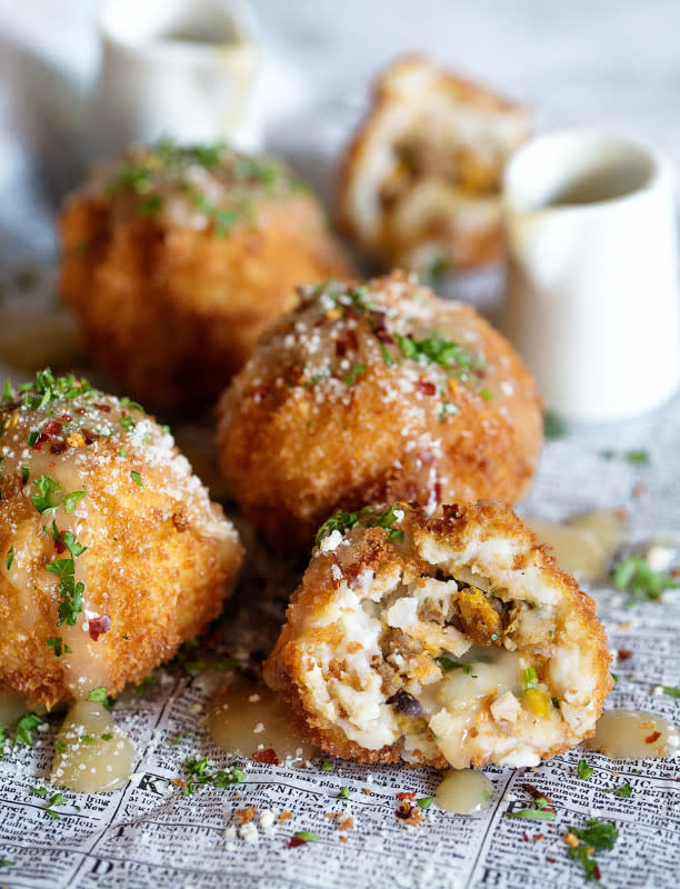 <p>Real Food by Dad</p><p>Deep fried balls that are dipped in panko and stuffed with dressing, chopped turkey and Parmesan cheese, then drizzled and dipped in gravy? It’s Thanksgiving in a bite and the best vehicle for leftovers. </p><p><strong>Get the recipe: <a href="https://realfoodbydad.com/thanksgiving-leftover-balls/" rel="nofollow noopener" target="_blank" data-ylk="slk:Thanksgiving Leftover Balls;elm:context_link;itc:0;sec:content-canvas" class="link rapid-noclick-resp">Thanksgiving Leftover Balls</a></strong></p>