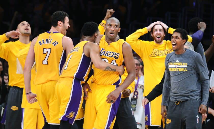 LOS ANGELES, CALIFORNIA APRIL 13, 2016- Lakers Kobe Bryant is mobbed as he scores 60-points in his final NBA game at the Staples Center Wednesday. (Wally Skalij/Los Angeles Times)