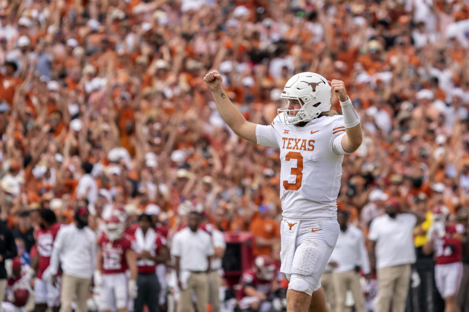 Texas quarterback Quinn Ewers (3) celebrates after a touchdown during the second half of an NCAA college football game against Oklahoma at the Cotton Bowl, Saturday, Oct. 8, 2022, in Dallas. Texas won 49-0. (AP Photo/Jeffrey McWhorter)