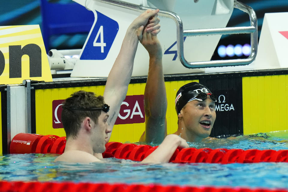 Hunter Armstrong, right, of the United States celebrates with Justin Ress of the United States after their men's 50m backstroke finalat the 19th FINA World Championships in Budapest, Hungary, Saturday, June 25, 2022. Justin Ress was disqualified and Hunter Armstrong won the gold. (AP Photo/Petr David Josek)