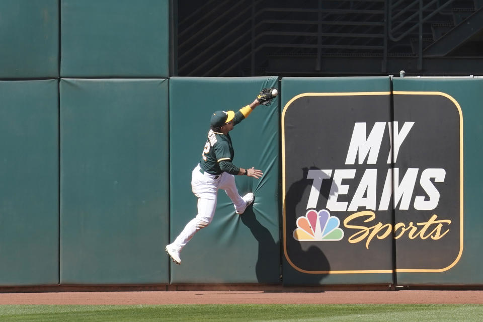 Oakland Athletics center fielder Ramon Laureano catches a fly ball during the eighth inning of a baseball game in Oakland, Calif., Sunday, May 2, 2021. (AP Photo/Jeff Chiu)