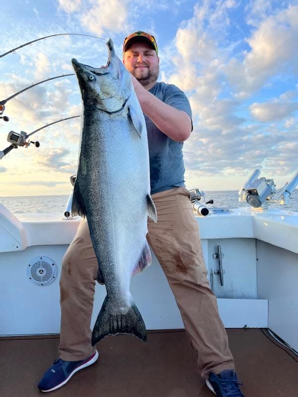 Brian Sollars of East Bethel, Minnesota, holds the 40.4-pound chinook salmon he caught July 31 while fishing in Lake Michigan on a charter boat.