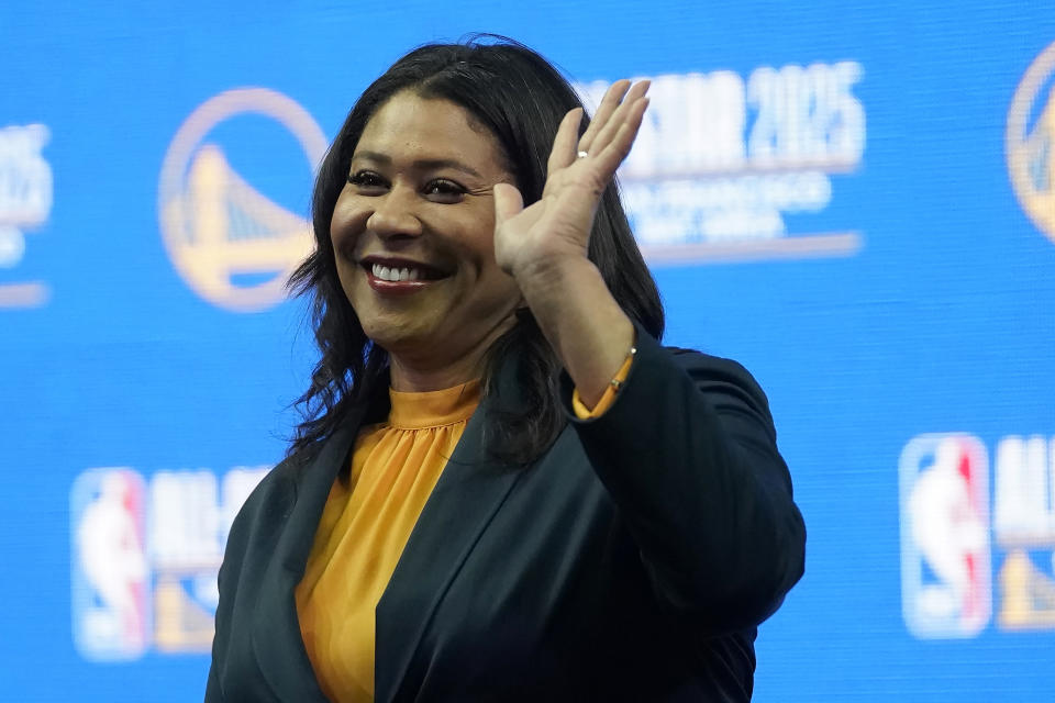 San Francisco Mayor London Breed waves at a news conference announcing that the 2025 NBA All-Star Game will be played in San Francisco at the Chase Center in San Francisco, Monday, Nov. 6, 2023. Thousands of CEOs, press, world leaders, protesters and others will descend on San Francisco for a global trade summit that could give the much maligned city a chance to shine. Mayor Breed has been promoting new pop-up shops, destinations and restaurants in a downtown struggling to regain foot traffic post-pandemic. (AP Photo/Jeff Chiu)