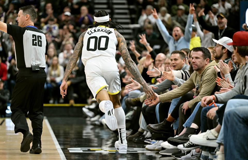 Utah Jazz guard Jordan Clarkson (00) fives fans after draining a three point shot as Utah and Los Angeles play at the Delta Center in Salt Lake City on Saturday, Jan. 13, 2024.