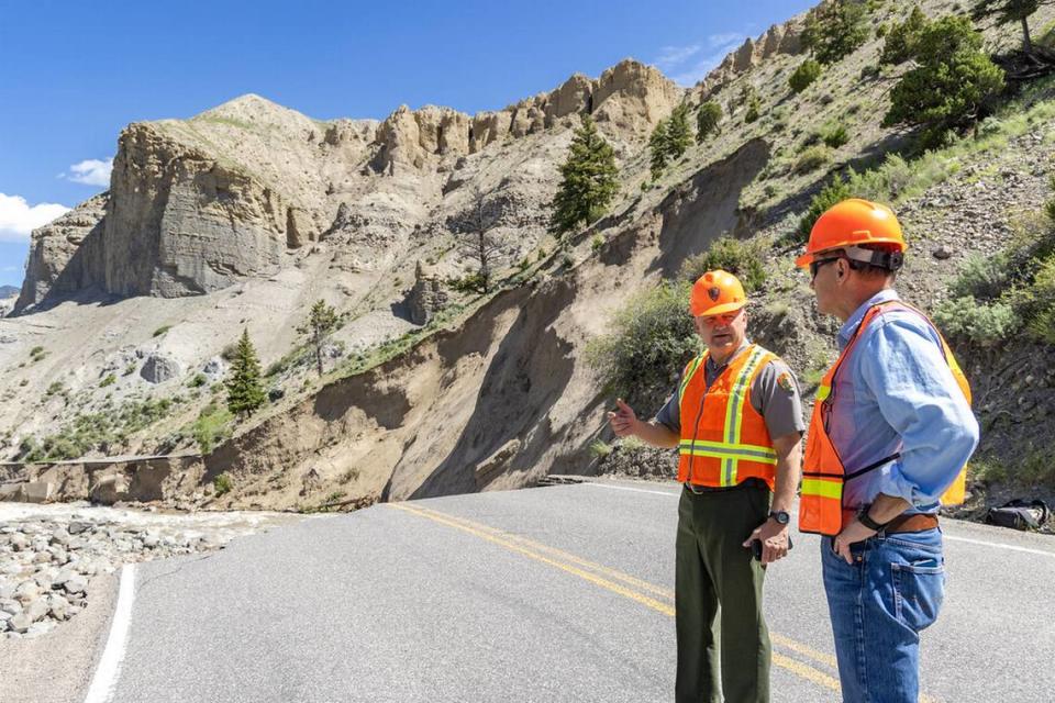 Yellowstone Superintendent Cam Sholly and Chief of Facility Maintenance Duane Bubac look at damage in Gardner River Canyon.