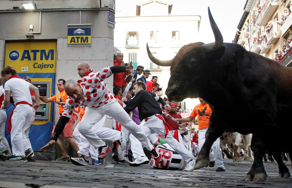 epa07713761 Several 'mozos', or runners, are chased by bulls of La Palmosilla ranch during the seventh 'encierro,' or running-with-the-bulls, of the Sanfermines festivities in Pamplona, Spain, 13 July 2019. The festival of San Fermin, locally known as Sanfermines, is held annually from 06 to 14 July in commemoration of the city's patron saint. Hundreds of thousands of visitors from all over the world attend the fiesta. Many of them physically participate in the highlight event - the running of the bulls, or encierro - where they attempt to outrun the bulls along a route through the narrow streets of Pamplona's old city.  EPA/Villar Lopez