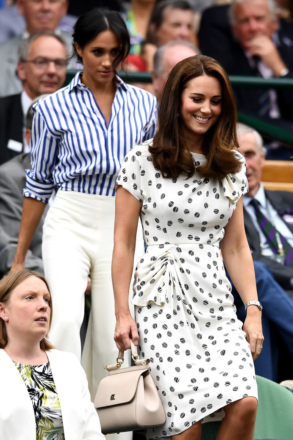 <p>Kate leads Meghan to their seats. </p>