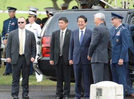 Japanese Prime Minister Shinzo Abe smiles as he talks with Director of the National Memorial of the Pacific James Horton (R) before presenting a wreath at the National Memorial Cemetery of the Pacific at Punchbowl in Honolulu, Hawaii, U.S. December 26, 2016. REUTERS/Hugh Gentry