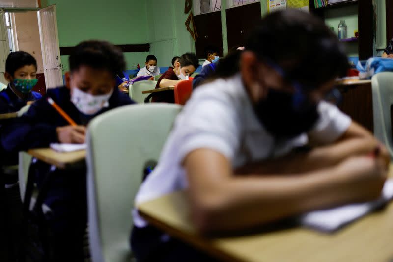 Students wearing protective masks attend a class in person as the coronavirus disease (COVID-19) outbreak continues, in Ciudad Juarez