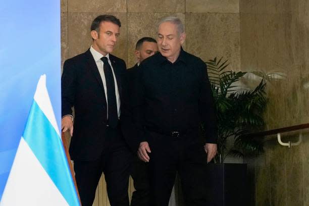 French president Emmanuel Macron and Israeli prime minister Benjamin Netanyahu (R) arrive for their joint press conference in Jerusalem on 24 October 2023 (AFP via Getty Images)