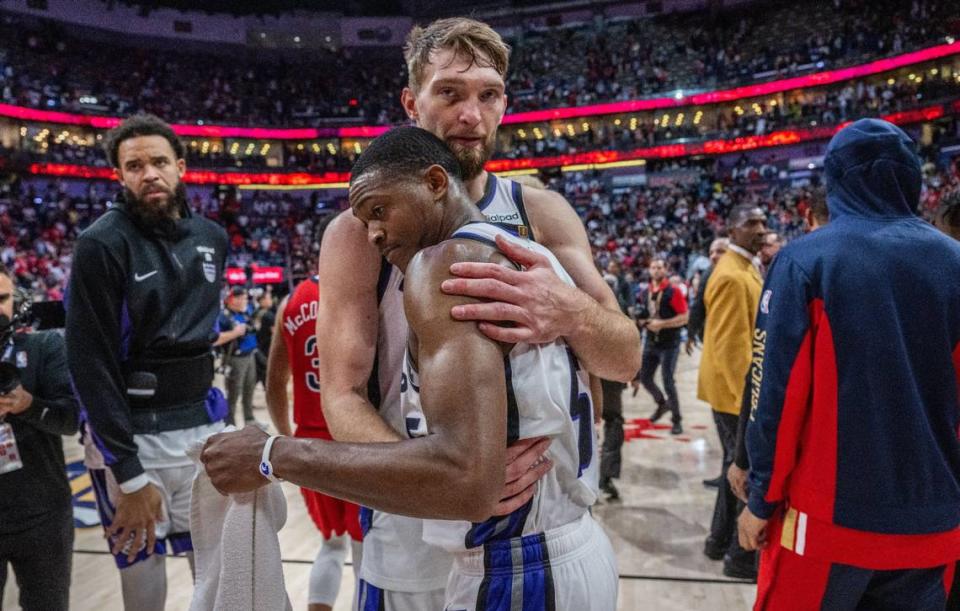 Sacramento Kings forward Domantas Sabonis (10) hugs guard De’Aaron Fox (5) after being eliminated from the playoffs during an NBA play-in game at Smoothie King Center in New Orleans on Friday, April 19, 2024. Hector Amezcua/hamezcua@sacbee.com