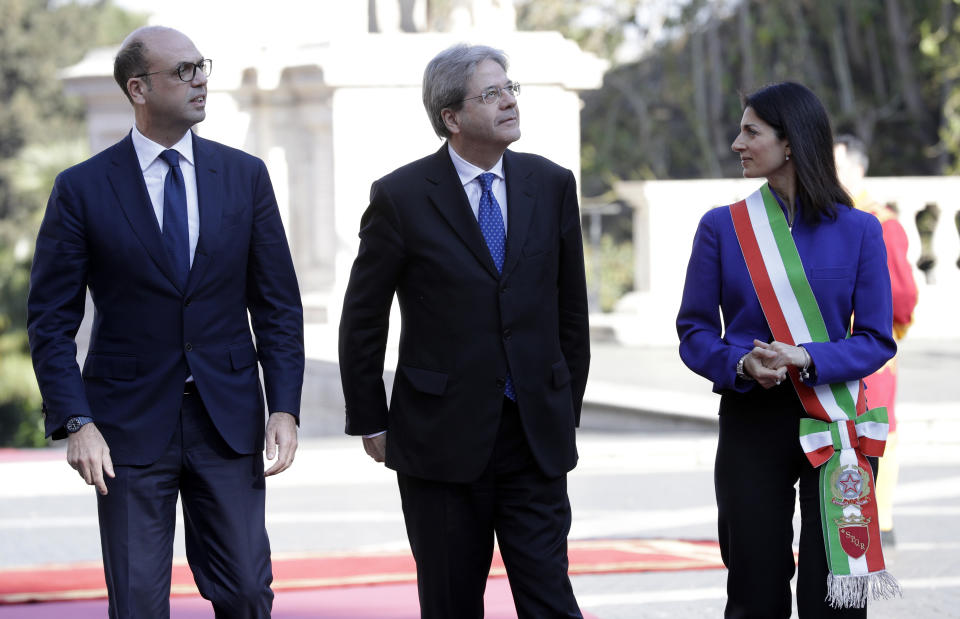 The Mayor of Rome, Virginia Raggi, right, stands with Italian Prime Minister Paolo Gentiloni, center, and Italian Foreign Minister Angelino Alfano, left, during arrivals for an EU summit at the Palazzo dei Conservatori in Rome on Saturday, March 25, 2017. EU leaders gather in Rome on Saturday to celebrate the 60th anniversary of the EU's founding treaty. (AP Photo/Andrew Medichini)