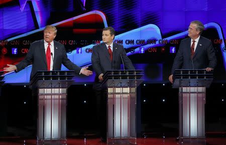 Republican U.S. presidential candidate businessman Donald Trump (L) responds to criticism from former Governor Jeb Bush (R) as Senator Ted Cruz (C) looks on during the Republican presidential debate in Las Vegas, Nevada December 15, 2015. REUTERS/Mike Blake