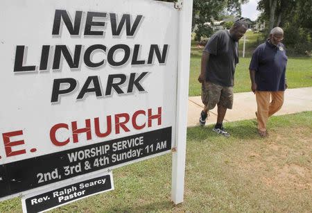 George Smith IV (L) walks with Henry Wilder with the Thomaston-Upson County Branch of the NAACP in the Lincoln Park neighborhood in Thomaston, Georgia, U.S. August 16, 2016. REUTERS/Tami Chappell