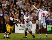 Quarterback Eli Manning #10 of the New York Giants throws the ball as teammate Chris Snee #76 blocks Barry Cofield #96 of the Washington Redskins in the first half at FedExField on December 3, 2012 in Landover, Maryland. (Photo by Rob Carr/Getty Images)