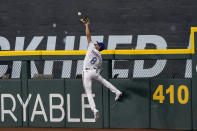 Texas Rangers left fielder Bubba Thompson makes the catch at the wall on a line drive by Philadelphia Phillies' Jake Cave during the eighth inning of an opening-day baseball game Thursday, March 30, 2023, in Arlington, Texas. (AP Photo/Jeffrey McWhorter)