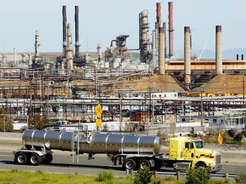 This March 9, 2010, file photo shows a tanker truck passing the Chevron oil refinery in Richmond, Calif. 