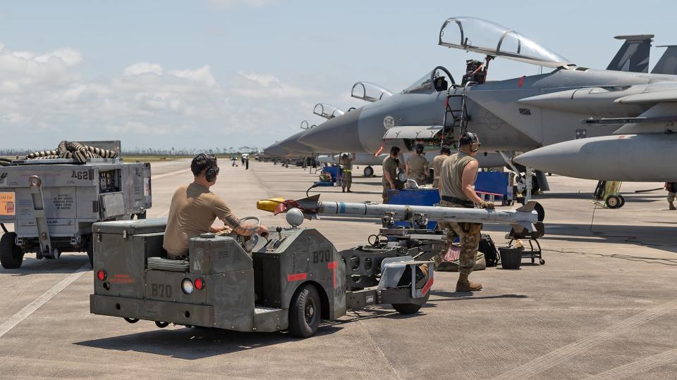 Maintainers load live weapons ahead of a Combat Archer mission. <em>Richard Collens</em>