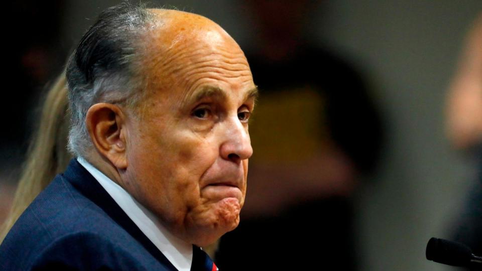 PHOTO: Rudy Giuliani, personal lawyer of President Donald Trump, looks on during an appearance before the Michigan House Oversight Committee in Lansing, Michigan, Dec. 2, 2020.  (Jeff Kowalsky/AFP via Getty Images)