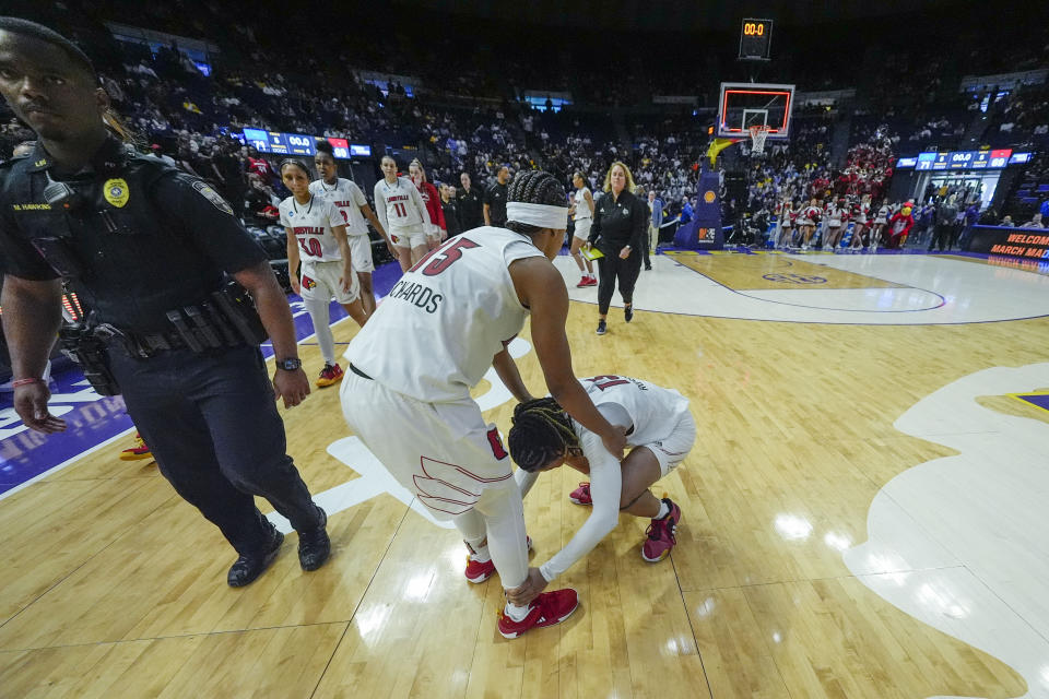 Louisville guard Nina Rickards (15) comforts guard Merissah Russell (13) after losing to Middle Tennessee in a first-round college basketball game in the women's NCAA Tournament in Baton Rouge, La., Friday, March 22, 2024. Middle Tennessee won 71-69. (AP Photo/Gerald Herbert)