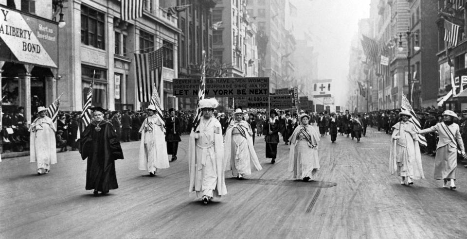 Supporters of women’s suffrage march in 1915 on New York’s Fifth Avenue.